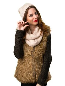 Girl with winter clothes making tiny sign Stock Photos