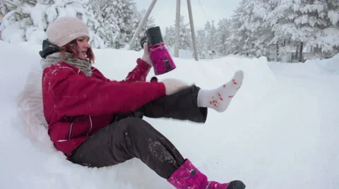 Girl wiping snow out of her shoes Stock Footage 59777050