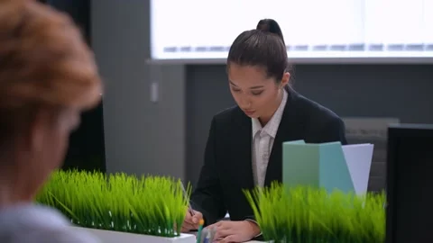 The girl worker in the office sits at the computer, takes notes Stock Footage 233717255