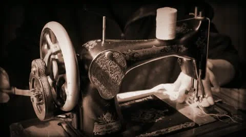 Girl working at an antique sewing machine Stock Footage