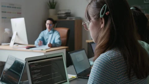 Girl Working on Code on her Laptop, Teacher Observing Students During IT Class Stock Footage 317638044