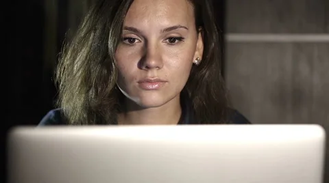 Girl working on computer in the evening in the interior with water background Stock Footage 42046589