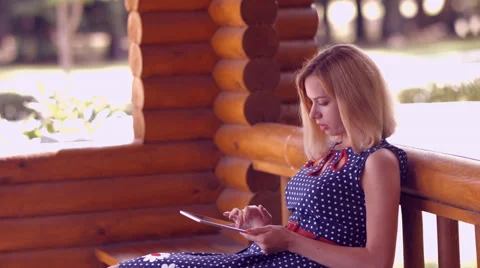 Girl working on a tablet computer in the park Stock Footage 51935943