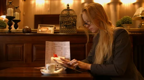 Girl working with tablet computer in restaurant Stock Footage 63046502