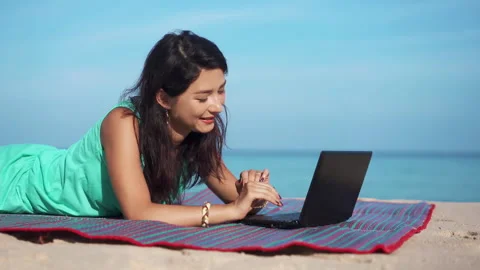 Girl working while being on vacation in paradise. Pretty young woman using Stock-Footage 144434194