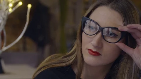 Girl works at the computer screen reflected in her glasses looked out the window 스톡 동영상 71697428