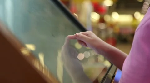 The girl works with a large tablet touchscreen Stock Footage 64513372