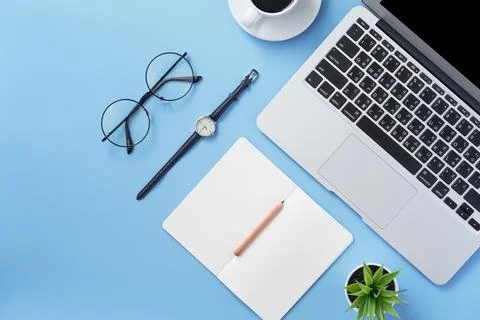 Girl write on open white book or accounting on a minimal clean light blue d.. Photos