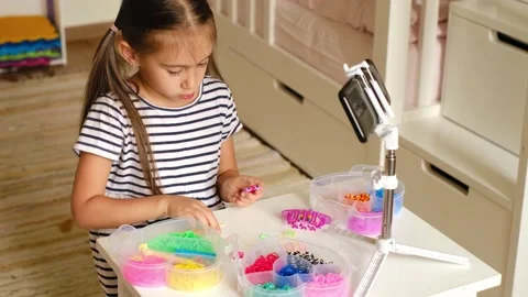 Girl writes down instructions for weaving rubber bands Stock Footage 165133196