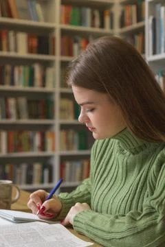 Girl writes down a summary of the training session in a notebook. Stock Photos