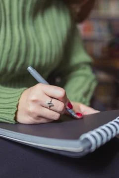 Girl writes down a summary of the training session in a notebook. Stock Photos