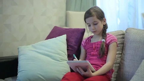 A girl writes draws in Notebook Stock Footage 73359121