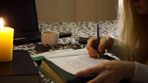 The girl writes in a notebook and drinks coffee Stock Footage 85897967