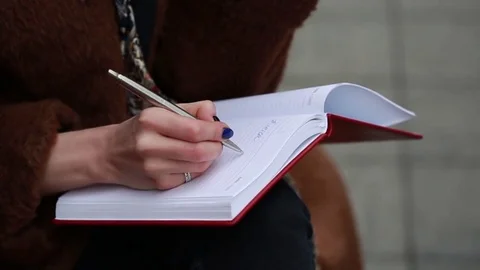 Girl writes in notebook. Close up Stock Footage 74304660