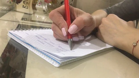 Girl writes in a notebook Video stock 120350823