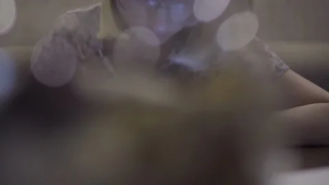 The girl writes in the notebook notes. Sitting in the living room at the table Stock Footage 113225679