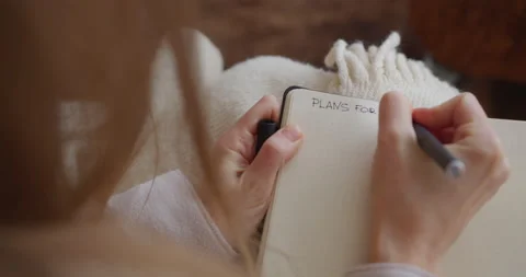 Girl writes in a notebook plan of the day/ inspiration, planning, handwriting Stock-Footage 170898242