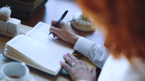 The girl writes with a pen in a notebook Stock Footage 184820361