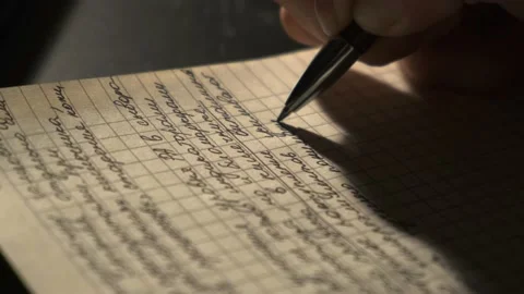 The girl writes something in a notebook, an entry in a notebook, a close-up Stock Footage 220715647