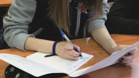 The girl writes the text in a notebook indoors Stock Footage 70147714