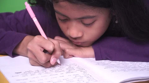 Girl is writing in book, making notes on a diary Stock Footage 310971541