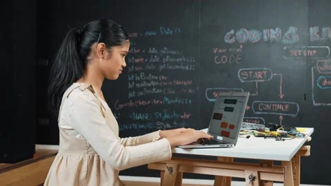 Girl writing code or engineering prompt while attend in STEM class. Edification Stock Footage 267920468