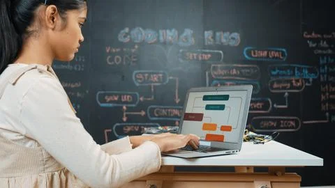 Girl writing code or engineering prompt while attend in STEM class. Edification. Stock Photos