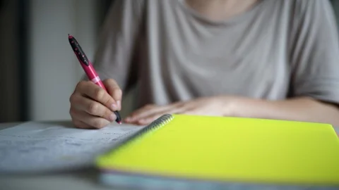 Girl writing down while studying Stock Footage 88567786
