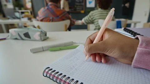 Girl Writing Math Equations in Notebook in Classroom Vídeos de archivo 340549923