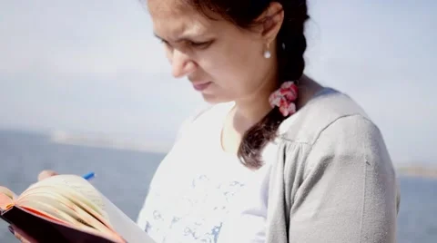 Girl writing in a notebook Stock Footage 68931554