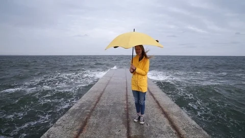 Girl in yellow rain cover with yellow Stock Video Pond5