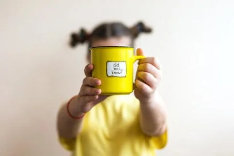 A girl with a yellow ring in her hand, on which was written Did you know Stock Photos