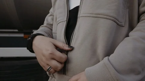 Girl zips up Stock Footage 129608917