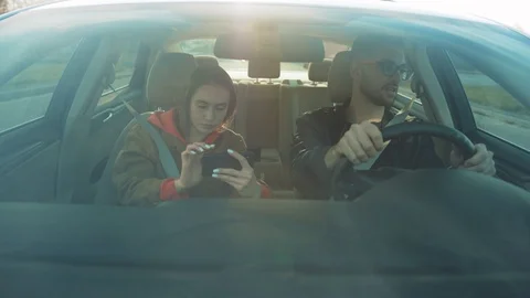 Girlfriend and guy in spectacles sitting in car. Girl telling where to go Stock Footage 110869707