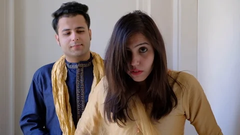 Girlfriend gets ready looking at the mirror with makeup and husband waits and ad Stock Footage 100631097