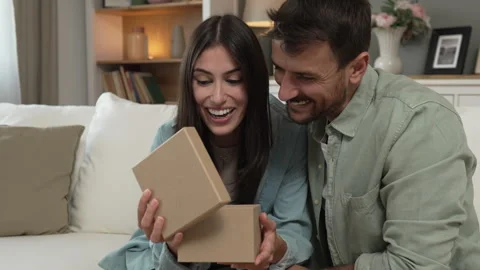 Girlfriend open her birthday present from her boyfriend at home Stock Footage 277610945