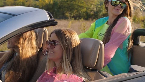 Girlfriends in a convertible car Stock Footage 100733033