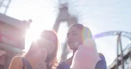 Girlfriends Eating Candy At Amusement Park Stock Footage