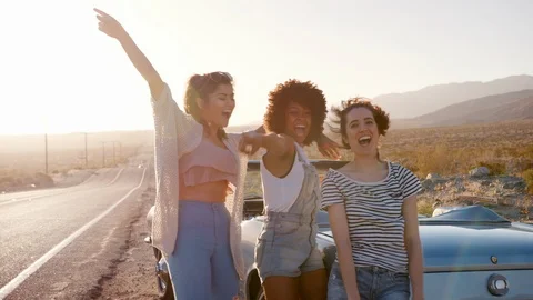 Girlfriends having a fun break on their road trip, close up Stock Footage 95963026