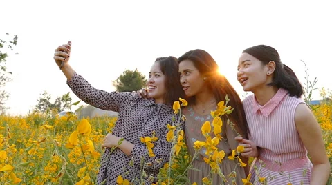 Girlfriends making self portrait by smart phone Stock Footage 62359061