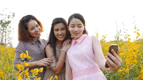 Girlfriends making self portrait by smart phone Stock Footage 62359089