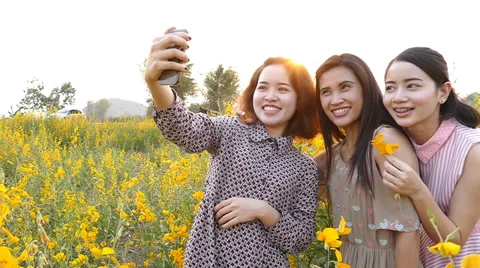 Girlfriends making self portrait by smart phone Stock Footage 62359198