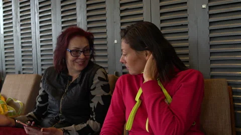 Girlfriends talk while sitting in a cafe Stock Footage 91397659