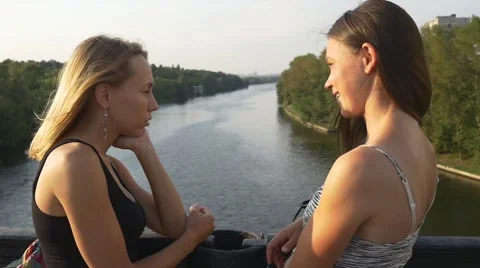 Girlfriends talking on a bridge Stock Footage 66482651