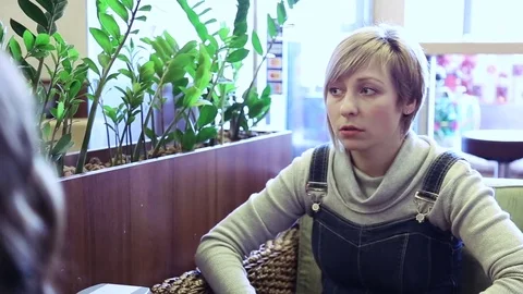 Girlfriends talking in cafe Stock Footage 72296388