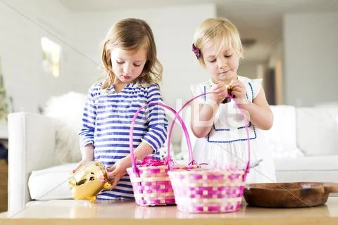 Girls (2-3, 4-5) opening candies Stock Photos