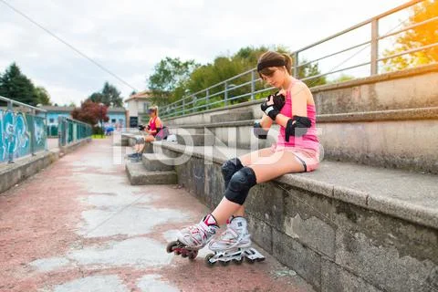 Girls are preparing to do rollerblading in the field Stock Photos