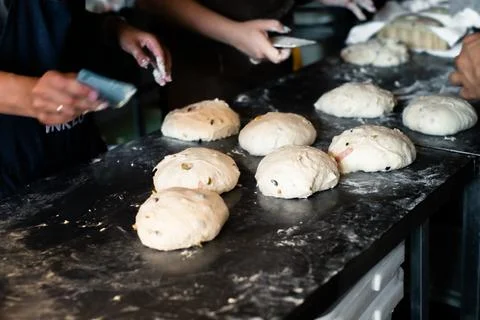 Girls bakers shape bread on the table Stock Photos