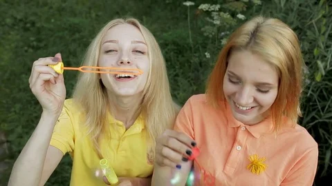 Girls blowing bubbles Stock Footage 78613813