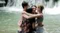 girls of boys have fun in a waterfall. hugging and playing with water HD Footage